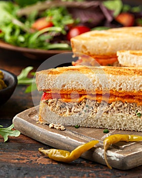 Homemade tuna melt sandwich on rustic board