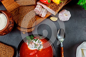 Homemade Ukrainian national soup - red borscht made of beetrot, vegetables and meat with brown bread, garlic, pepper