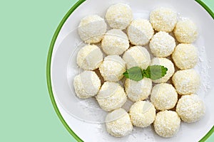 Homemade unbaked coconut balls on a plate