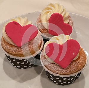 Homemade Vanilla Buttercream cupcake decorate with heart sugarpaste or marzipan