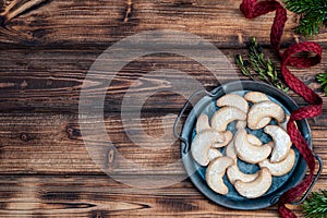 Homemade vanilla christmas cokkies on a metal tray on a wooden background.