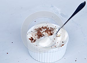 Homemade vanilla ice cream with chocolate chips  in a bowl with a spoon.