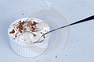 Homemade vanilla ice cream with chocolate chips  in a bowl with a spoon.