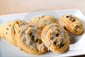 Homemade vanilla, orange, lemon chocolate chip cookies biscuits stack on a white plate