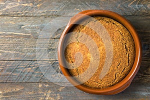 Homemade vegan cake or sourdough bread with carrots bran from spelt dinkel wheat flour in clay baking form on rustic wooden table