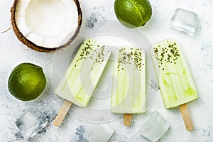 Homemade vegan frozen coconut mojito popsicles - ice pops - paletas with chia seeds. photo