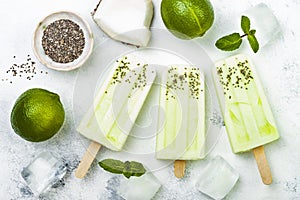 Homemade vegan frozen coconut mojito popsicles - ice pops - paletas with chia seeds. photo