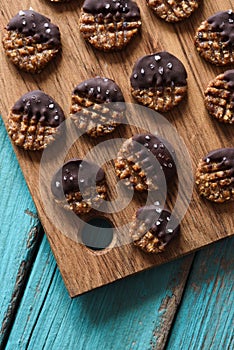 Homemade vegan gluten free cookies with chocolate and himalayan salt on blue background copyspace