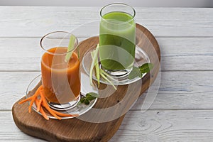 Homemade vegan green juice with vegetables, carrots, celery and herbs. Antioxidant drink