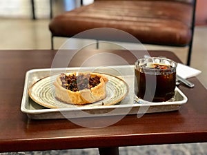 Homemade Vegetable Quiche Tart with Seasonings and Cold Brew Coffee at Cafe Shop / Restaurant.