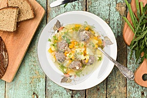 Homemade vegetable soup with meatballs served with rye bread and