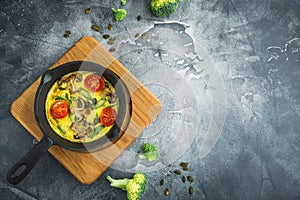 Homemade vegetarian soup in white bowl on dark backgroundHealthy vegetarian omelet in frying pan and pumpkin seeds. Flat lay, top