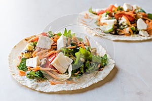 Homemade Vegetarian Tostadas with Salad, Cheese and Grated Carrot Slices.