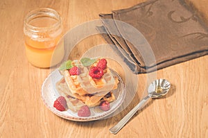 Homemade waffles with berries, honey in plate/Homemade waffles with berries, honey in plate on a old wooden background, selective