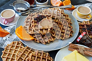 Homemade waffles with blueberry jam and peanut butter.