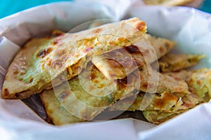 Homemade wheat paratha stuffed colliflower and onion. Gobi Paratha cutted into pieces, close up