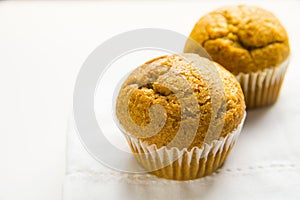 Homemade Whole Wheat Bran Carrot Pumpkin Muffins son White Cotton Kitchen Towel. Breakfast Morning Sunlight. Healthy Pastry