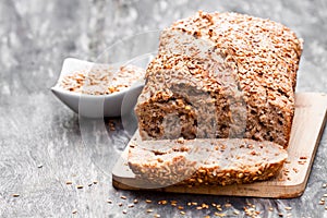 Homemade wholemeal rye bread with flax seeds on wooden table