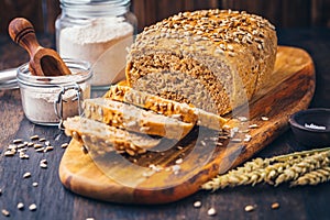 Homemade wholemeal spelt bread with sunflower seeds and baking ingredients