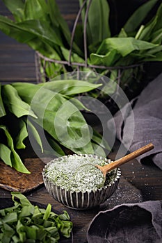 Homemade wild garlic salt and fresh green leaves