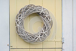 Homemade Wood vine wreath with Star fish hanging on a New England Coastal Cottage Door