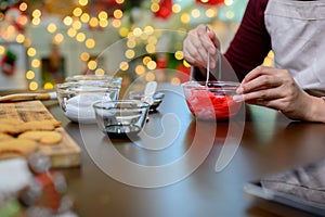 Homemade Xmas cookie for Christmas and Happy New Year. Woman cooking gingerbread with friend and Family on winter holiday