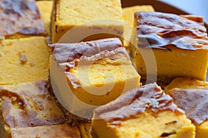 Homemade yellow orange cheesecake in pieces