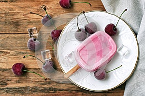 Homemade yoghurt ice cream eskim on stick with cherry