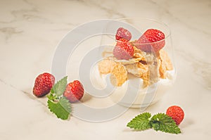 Homemade yogurt with corn flakes, strawberry and mint/Homemade yogurt with corn flakes, strawberry and mint on a white background