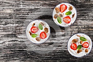 Homemade yogurt in cups with whole grain flakes