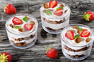 Homemade yogurt in cups with whole grain flakes