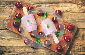 Homemade yogurt ice cream, with cherry, popsicle on stick