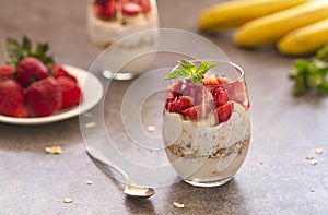 Homemade yogurt parfait with granola, strawberries, bananas and Chia seeds in glasses. Diet dessert with yogurt.