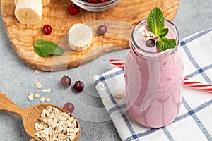 Homemade yogurt smoothie with banana, cranberry and oatmeal