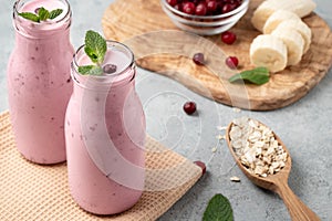 Homemade yogurt smoothie with banana, cranberry and oatmeal