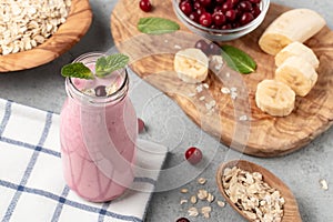 Homemade yogurt smoothie with banana, cranberry and oatmeal