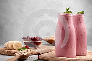 Homemade yogurt smoothie with banana, cranberry and oatmeal, copy space