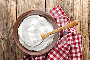 Homemade yogurt or sour cream in a rustic bowl photo