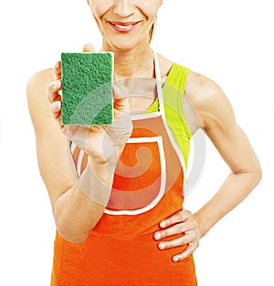 Homemaker in an apron holding a sponge washer