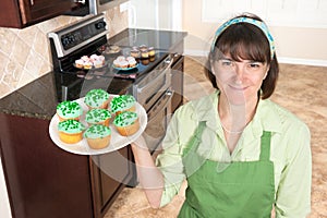 Homemaker holding cupcakes