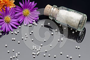 Homeopathic globules on a black acrylic background
