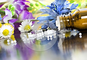 Homeopathic globules with blooms photo