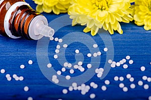 Homeopathic globules on a blue  wooden background