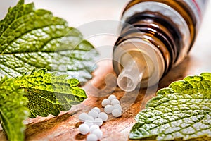 Homeopathic tablets on wooden table