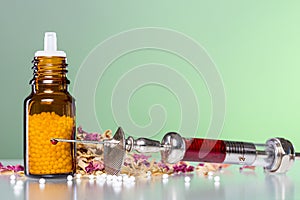 Homeopathy globule, syringe with blood and some photo