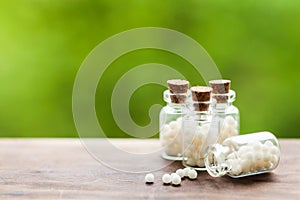 Homeopathy pills in vintage bottles photo