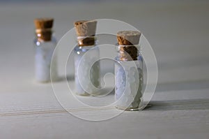 Homeopathy pills in vintage bottles on white background.