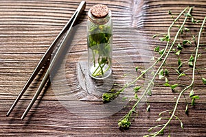 Homeopathy. Store up medicinal herbs. Herbs in glass on wooden table background