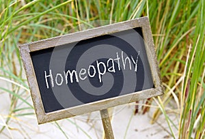 Homeopathy - wooden chalkboard with text