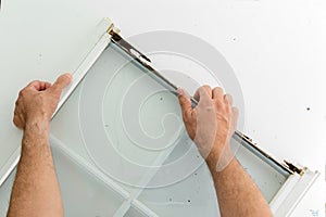 Homeowner replacing a damaged window frame photo